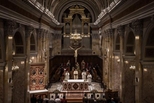 TOPSHOT - Congregants gather during the Maundy Thursday’s Washing of the Feet ceremony at the Christ the Saviour Church in the old city of Jerusalem, on April 2, 2026. Holy sites in Jerusalem's old city have remained closed for security reasons since the outbreak of the Middle East war on February 28, when Israel and the US launched strikes on Iran. (Photo by MARCO LONGARI / AFP)