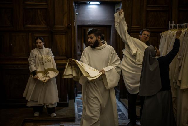 Deacons prepare garments ahead of the Maundy Thursday’s Washing of the Feet ceremony at the Christ the Saviour Church in the old city of Jerusalem, on April 2, 2026. Holy sites in Jerusalem's old city have remained closed for security reasons since the outbreak of the Middle East war on February 28, when Israel and the US launched strikes on Iran. (Photo by MARCO LONGARI / AFP)