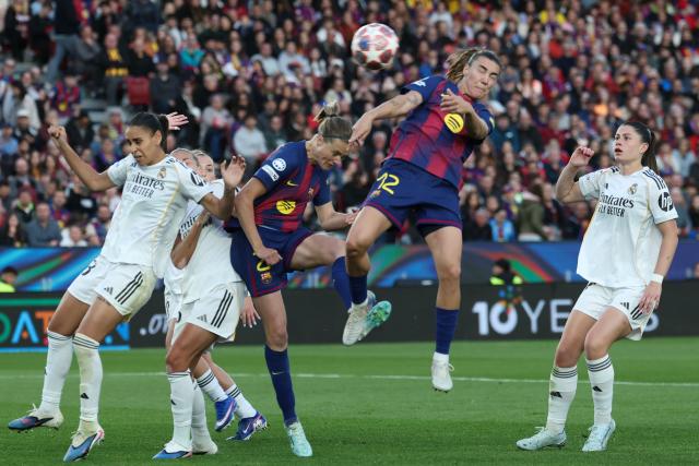 Barcelona's Spanish midfielder Patricia Guijarro (C) heads the ball during the UEFA Women's Champions League quarter final second leg football match between FC Barcelona and Real Madrid CF at the Camp Nou stadium in Barcelona on April 2, 2026. (Photo by Lluis GENE / AFP)
