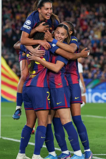 Barcelona's Dutch forward #24 Esmee Brugts (L) celebrates with teammates after scoring their sixth goal during the UEFA Women's Champions League quarter final second leg football match between FC Barcelona and Real Madrid CF at the Camp Nou stadium in Barcelona on April 2, 2026. (Photo by Lluis GENE / AFP)