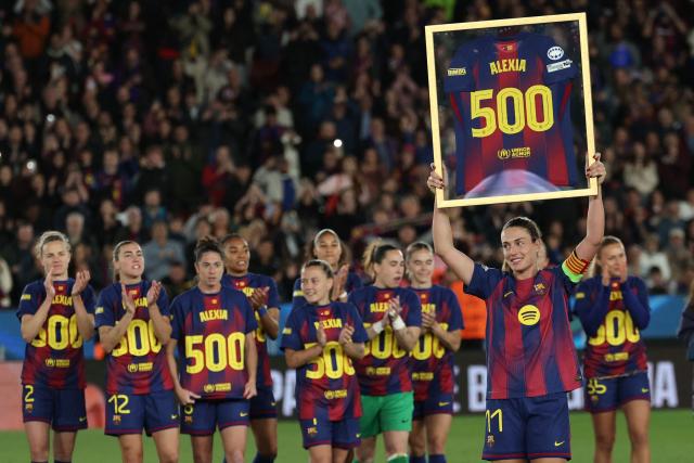 Barcelona's Spanish midfielder #11 Alexia Putellas holds up a jersey to celebrate her 500th appearance with Barcelona after the UEFA Women's Champions League quarter final second leg football match between FC Barcelona and Real Madrid CF at the Camp Nou stadium in Barcelona on April 2, 2026. (Photo by Lluis GENE / AFP)