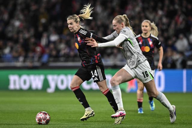 Lyon's Norwegian forward #14 Ada Hegerberg (L) fights for the ball with VfL Wolfsburg's German defender #16 Camilla Kuver (R) during the UEFA Women's Champions League quarter final second leg football match between OL Lyonnes (Lyon) and VfL Wolfsburg at the Groupama stadium in Decines-Charpieu, central-eastern France, on April 2, 2026. (Photo by JEFF PACHOUD / AFP)