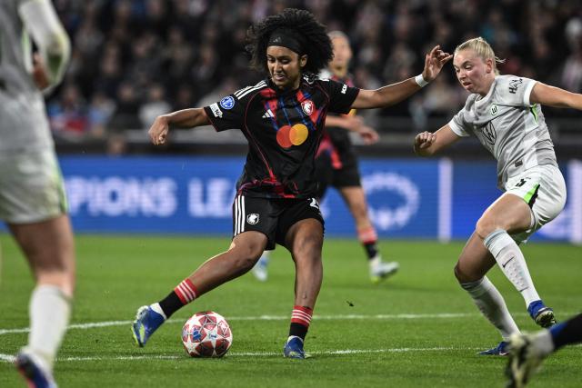 Lyon's US midfielder #20 Lily Yohannes (C) shoots to score her team's first goal during the UEFA Women's Champions League quarter final second leg football match between OL Lyonnes (Lyon) and VfL Wolfsburg at the Groupama stadium in Decines-Charpieu, central-eastern France, on April 2, 2026. (Photo by JEFF PACHOUD / AFP)