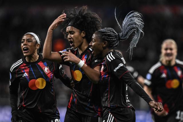 Lyon's US midfielder #20 Lily Yohannes (C) celebrates with teammates after scoring her team's first goal during the UEFA Women's Champions League quarter final second leg football match between OL Lyonnes (Lyon) and VfL Wolfsburg at the Groupama stadium in Decines-Charpieu, central-eastern France, on April 2, 2026. (Photo by JEFF PACHOUD / AFP)