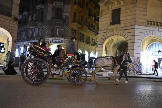 Visitors ride on a horse carriage before the closing of shops in downtown Cairo on April 2, 2026. (Photo by Khaled DESOUKI / AFP)