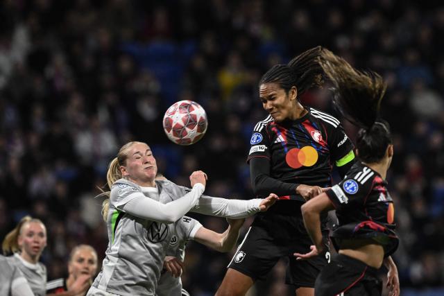 Lyon's French defender #03 Wendie Renard (R) fights for the ball with VfL Wolfsburg's German defender #16 Camilla Kuver (L) during the UEFA Women's Champions League quarter final second leg football match between OL Lyonnes (Lyon) and VfL Wolfsburg at the Groupama stadium in Decines-Charpieu, central-eastern France, on April 2, 2026. (Photo by JEFF PACHOUD / AFP)