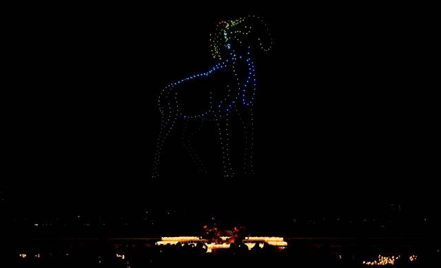 A string quartet performs as over 1,000 drones form a figure in the sky during the DroneArt show in Milan, on April 2, 2026. (Photo by Stefano RELLANDINI / AFP)