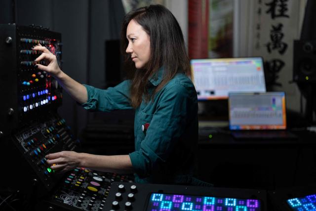 French producer-singer-songwriter of electronic music Cecile Leoge, aka DeLaurentis, poses in her music studio at home during a photo session in Paris, on March 31, 2026. (Photo by Joel Saget / AFP)