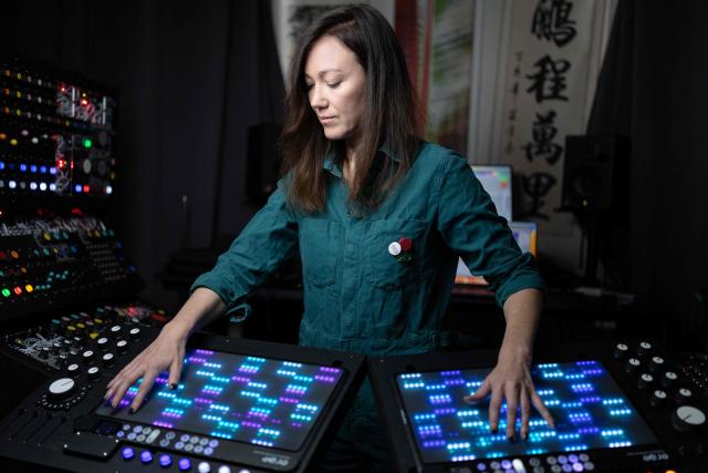 French producer-singer-songwriter of electronic music Cecile Leoge, aka DeLaurentis, poses in her music studio at home during a photo session in Paris, on March 31, 2026. (Photo by Joel Saget / AFP)