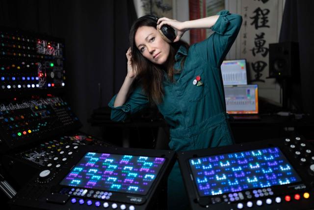 French producer-singer-songwriter of electronic music Cecile Leoge, aka DeLaurentis, poses in her music studio at home during a photo session in Paris, on March 31, 2026. (Photo by Joel Saget / AFP)