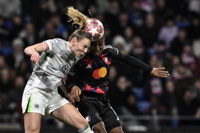 Lyon's Haitian midfielder #06 Melchie Dumornay (R) fights for the ball with VfL Wolfsburg's German midfielder #06 Janina Minge (L) during the UEFA Women's Champions League quarter final second leg football match between OL Lyonnes (Lyon) and VfL Wolfsburg at the Groupama stadium in Decines-Charpieu, central-eastern France, on April 2, 2026. (Photo by JEFF PACHOUD / AFP)