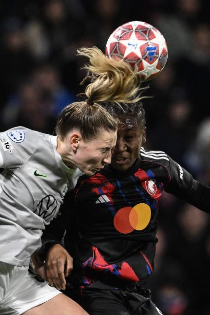 VfL Wolfsburg's German midfielder #06 Janina Minge (L) fights for the ball with Lyon's Haitian midfielder #06 Melchie Dumornay (R) during the UEFA Women's Champions League quarter final second leg football match between OL Lyonnes (Lyon) and VfL Wolfsburg at the Groupama stadium in Decines-Charpieu, central-eastern France, on April 2, 2026. (Photo by JEFF PACHOUD / AFP)