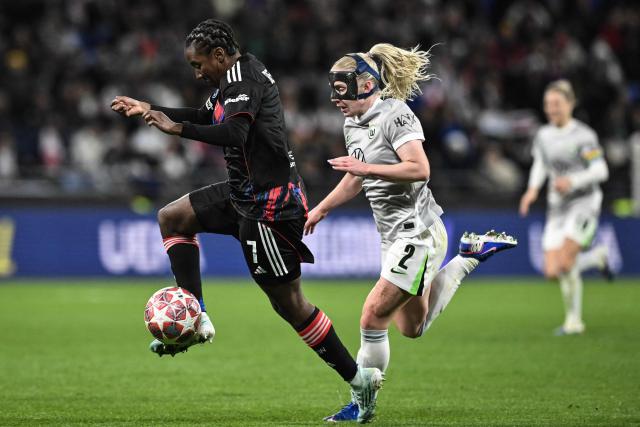 Lyon's French forward #07 Vicki Becho (L) fights for the ball with VfL Wolfsburg's Norwegian defender #02 Thea Bjelde (R) during the UEFA Women's Champions League quarter final second leg football match between OL Lyonnes (Lyon) and VfL Wolfsburg at the Groupama stadium in Decines-Charpieu, central-eastern France, on April 2, 2026. (Photo by JEFF PACHOUD / AFP)