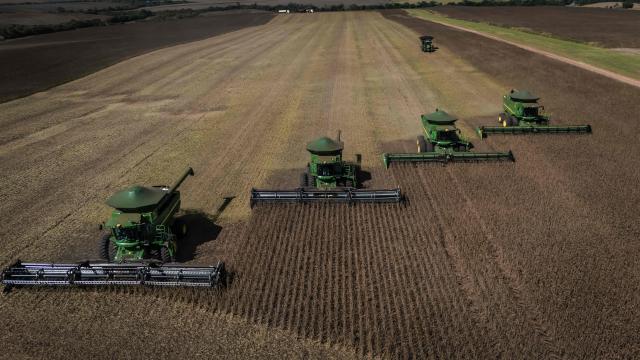 Aerial view of harvest machines working in a soybean field in Cruz Alta, Rio Grande do Sul state, Brazil, on April 2, 2026. (Photo by Silvio AVILA / AFP)