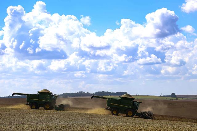 Harvest machines work in a soybean field in Cruz Alta, Rio Grande do Sul state, Brazil, on April 2, 2026. (Photo by SILVIO AVILA / AFP)
