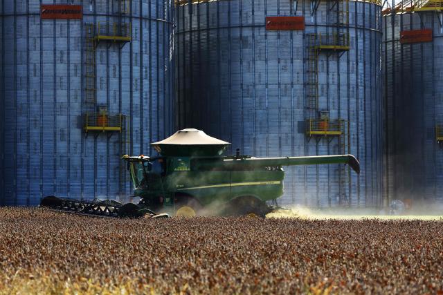 A harvest machine works in a soybean field in Cruz Alta, Rio Grande do Sul state, Brazil, on April 2, 2026. (Photo by SILVIO AVILA / AFP)