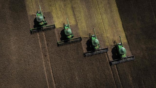 Aerial view of harvest machines working in a soybean field in Cruz Alta, Rio Grande do Sul state, Brazil, on April 2, 2026. (Photo by Silvio AVILA / AFP)