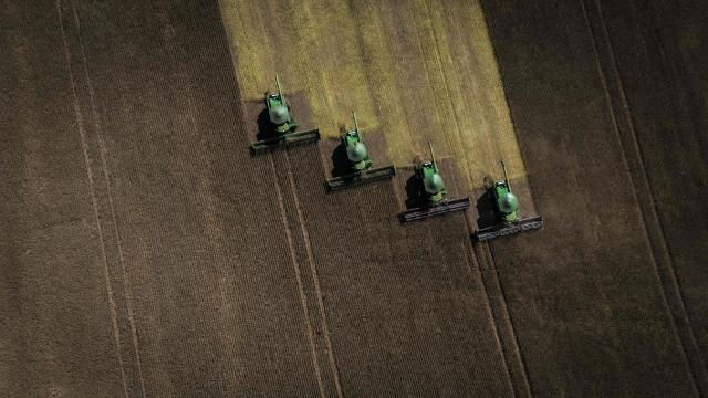 Aerial view of harvest machines working in a soybean field in Cruz Alta, Rio Grande do Sul state, Brazil, on April 2, 2026. (Photo by Silvio AVILA / AFP)