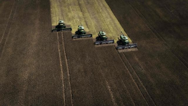Aerial view of harvest machines working in a soybean field in Cruz Alta, Rio Grande do Sul state, Brazil, on April 2, 2026. (Photo by Silvio AVILA / AFP)