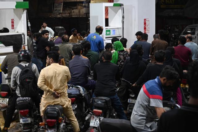 Clients queue at a gas station amid rising petrol prices in Karachi on April 3, 2026. US-Israel war on Iran, launched on February 28, has roiled global energy and equities markets, sending oil prices skyrocketing after Tehran virtually closed the key Strait of Hormuz. (Photo by Rizwan TABASSUM / AFP)
