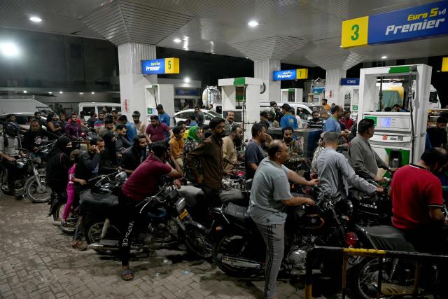 Clients queue at a gas station amid rising petrol prices in Karachi on April 3, 2026. US-Israel war on Iran, launched on February 28, has roiled global energy and equities markets, sending oil prices skyrocketing after Tehran virtually closed the key Strait of Hormuz. (Photo by Rizwan TABASSUM / AFP)