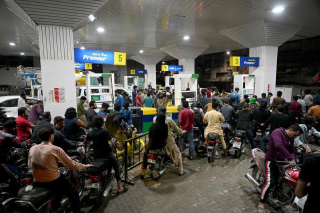 Clients queue at a gas station amid rising petrol prices in Karachi on April 3, 2026. US-Israel war on Iran, launched on February 28, has roiled global energy and equities markets, sending oil prices skyrocketing after Tehran virtually closed the key Strait of Hormuz. (Photo by Rizwan TABASSUM / AFP)