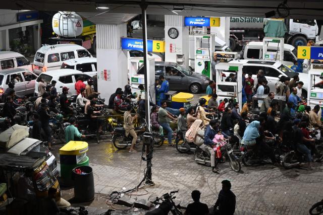 Clients queue at a gas station amid rising petrol prices in Karachi on April 3, 2026. US-Israel war on Iran, launched on February 28, has roiled global energy and equities markets, sending oil prices skyrocketing after Tehran virtually closed the key Strait of Hormuz. (Photo by Rizwan TABASSUM / AFP)