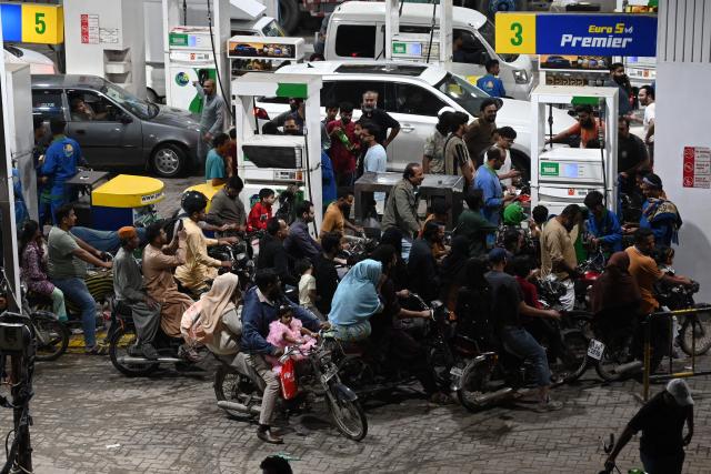 Clients queue at a gas station amid rising petrol prices in Karachi on April 3, 2026. US-Israel war on Iran, launched on February 28, has roiled global energy and equities markets, sending oil prices skyrocketing after Tehran virtually closed the key Strait of Hormuz. (Photo by Rizwan TABASSUM / AFP)