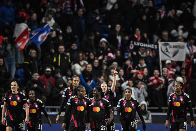 Lyon's Dutch midfielder #13 Damaris Egurrola (3rdR) celebrates with teammaes after scoring her team's third goal during the UEFA Women's Champions League quarter final second leg football match between OL Lyonnes (Lyon) and VfL Wolfsburg at the Groupama stadium in Decines-Charpieu, central-eastern France, on April 2, 2026. (Photo by JEFF PACHOUD / AFP)