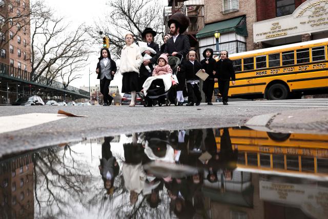 An Ultra-Orthodox Jewish family walks in a street of Williamsburg in the Brooklyn borough of New York during Passover (Pesach) on April 2, 2026. Pesach, which runs from April 1-9 this year, is a major eight-day Jewish holiday commemorating the biblical Exodus of the Israelites from Egyptian slavery. (Photo by CHARLY TRIBALLEAU / AFP)