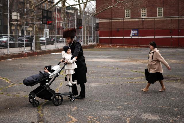 An Ultra-Orthodox Jewish family walks in a street of Williamsburg in the Brooklyn borough of New York during Passover (Pesach) on April 2, 2026. Pesach, which runs from April 1-9 this year, is a major eight-day Jewish holiday commemorating the biblical Exodus of the Israelites from Egyptian slavery. (Photo by CHARLY TRIBALLEAU / AFP)