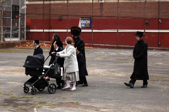An Ultra-Orthodox Jewish family walks in a street of Williamsburg in the Brooklyn borough of New York during Passover (Pesach) on April 2, 2026. Pesach, which runs from April 1-9 this year, is a major eight-day Jewish holiday commemorating the biblical Exodus of the Israelites from Egyptian slavery. (Photo by CHARLY TRIBALLEAU / AFP)