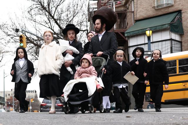 An Ultra-Orthodox Jewish family walks in a street of Williamsburg in the Brooklyn borough of New York during Passover (Pesach) on April 2, 2026. Pesach, which runs from April 1-9 this year, is a major eight-day Jewish holiday commemorating the biblical Exodus of the Israelites from Egyptian slavery. (Photo by CHARLY TRIBALLEAU / AFP)