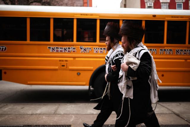 Ultra-Orthodox Jewish men walk in a street of Williamsburg in the Brooklyn borough of New York during Passover (Pesach) on April 2, 2026. Pesach, which runs from April 1-9 this year, is a major eight-day Jewish holiday commemorating the biblical Exodus of the Israelites from Egyptian slavery. (Photo by CHARLY TRIBALLEAU / AFP)