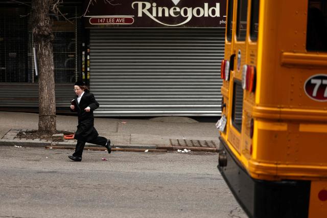 An Ultra-Orthodox Jewish boy runs in a street of Williamsburg in the Brooklyn borough of New York during Passover (Pesach) on April 2, 2026. Pesach, which runs from April 1-9 this year, is a major eight-day Jewish holiday commemorating the biblical Exodus of the Israelites from Egyptian slavery. (Photo by CHARLY TRIBALLEAU / AFP)