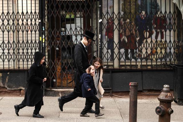 An Ultra-Orthodox Jewish family walks in a street of Williamsburg in the Brooklyn borough of New York during Pesach on April 2, 2026. Pesach, which runs from April 1-9 this year, is a major eight-day Jewish holiday commemorating the biblical Exodus of the Israelites from Egyptian slavery. (Photo by CHARLY TRIBALLEAU / AFP)