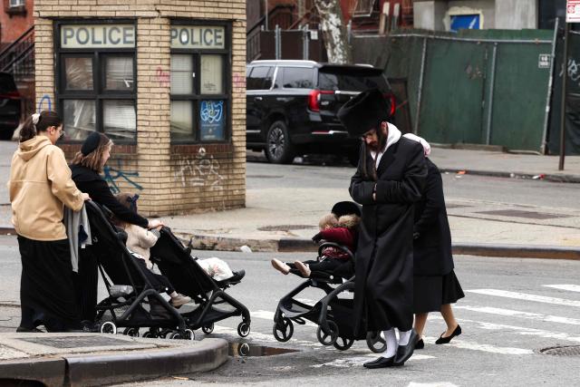An Ultra-Orthodox Jews walk in a street of Williamsburg in the Brooklyn borough of New York during Passover (Pesach) on April 2, 2026. Pesach, which runs from April 1-9 this year, is a major eight-day Jewish holiday commemorating the biblical Exodus of the Israelites from Egyptian slavery. (Photo by CHARLY TRIBALLEAU / AFP)