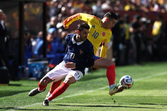 (FILES) Colombia's midfielder #10 James Rodriguez and France's defender #21 Lucas Hernandez fight for the ball during a friendly football match between Colombia and France at Northwest Stadium in Landover, Maryland, on March 29, 2026. Colombian star James Rodrнguez was hospitalized for three days in the United States following the March 29 friendly match against France due to “severe dehydration,” the Colombian Football Federation (FCF) reported on April 2, 2026. (Photo by FRANCK FIFE / AFP)
