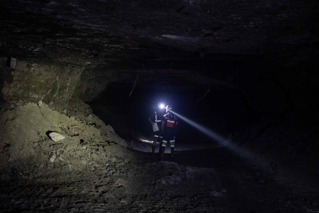 Miners walk along a corridor more than 1,000 meters underground at the Polkowice–Sieroszowice copper and silver mine in southwestern Poland, owned by KGHM, the metallurgical giant in the country, on March 25, 2026. Thousands of meters beneath the ground, amid suffocating heat, lies one of the keys to Poland's rumbling mining sector -- and the world economy. (Photo by Wojtek RADWANSKI / AFP)