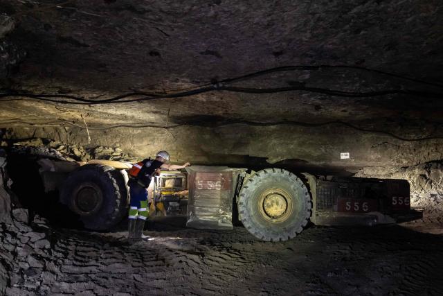 Miners use heavy machines to work more than 1,000 meters underground at the Polkowice–Sieroszowice copper and silver mine in southwestern Poland, owned by KGHM, the country's metallurgical giant, on March 25, 2026. Thousands of meters beneath the ground, amid suffocating heat, lies one of the keys to Poland's rumbling mining sector -- and the world economy. (Photo by Wojtek RADWANSKI / AFP)
