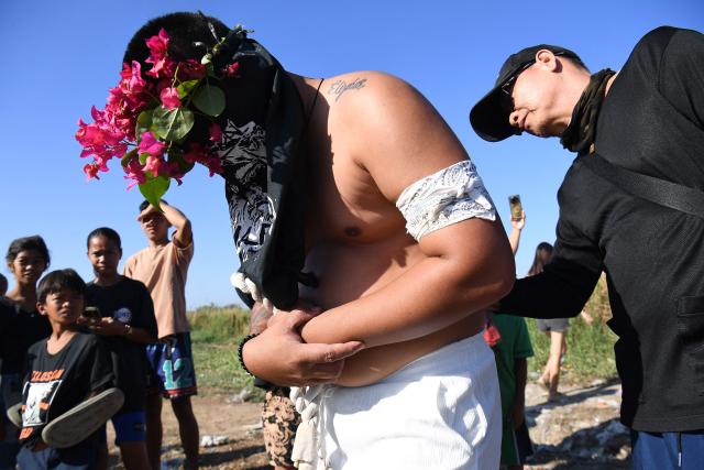 A man punctures the skin of penitents before flagellating themselves prior to the annual crucifixion during the observance of Lent in the village of Cutud in San Fernando City, Pampanga province on April 3, 2026. (Photo by Ted ALJIBE / AFP)