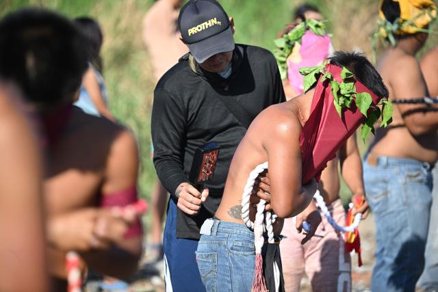 A man punctures the skin of penitents before flagellating themselves prior to the annual crucifixion during the observance of Lent in the village of Cutud in San Fernando City, Pampanga province on April 3, 2026. (Photo by Ted ALJIBE / AFP)