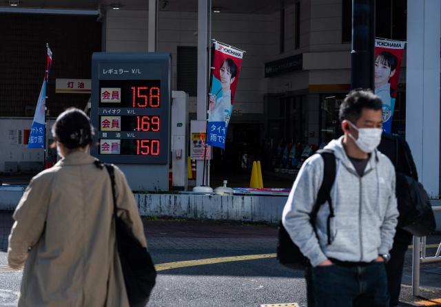 Morning commuters walk past a gas station in Tokyo on April 3, 2026. (Photo by ANDREW CABALLERO-REYNOLDS / AFP)