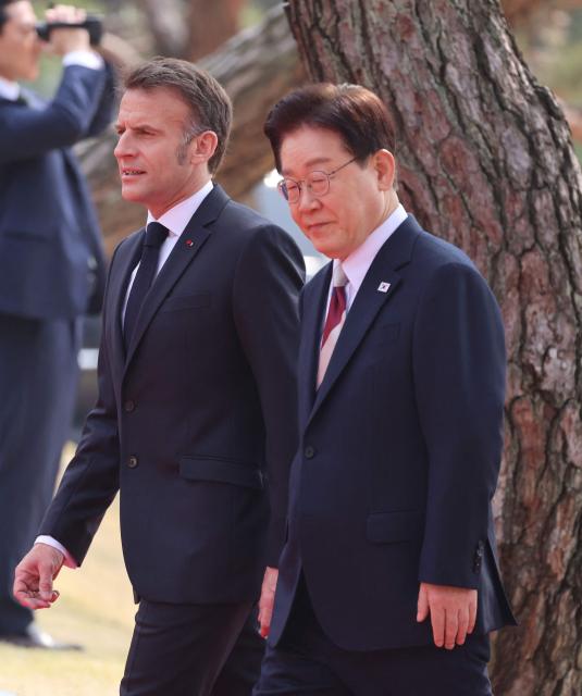 French President Emmanuel Macron (L) and South Korean President Lee Jae Myung attend the official welcome ceremony at the Blue House in Seoul on April 3, 2026. (Photo by Ludovic MARIN / AFP)