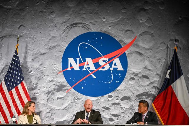 NASA Orion program manager Howard Hu (R) and and acting associate administrator for NASAs Exploration Systems Development Mission Directorate Lori Glaze (L) listen to NASA flight director Judd Frieling (C) speak during a status briefing of the Artemis II crewed lunar mission at Johnson Space Center in Houston, Texas, on April 2, 2026. On April 2, the four Artemis astronauts fired up their spacecraft's engine to break away from Earth's orbit and zoomed towards the Moon, a milestone that commits NASA to the first crewed lunar flyby in more than half-a-century. The 10-day Artemis 2 mission is aimed at paving the way for a Moon landing in 2028. (Photo by RONALDO SCHEMIDT / AFP)
