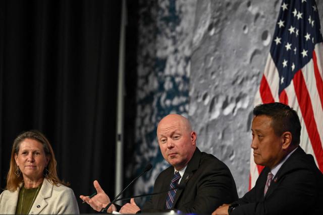 NASA Orion program manager Howard Hu (R) and and acting associate administrator for NASAs Exploration Systems Development Mission Directorate Lori Glaze (L) listen to NASA flight director Judd Frieling (C) speak during a status briefing of the Artemis II crewed lunar mission at Johnson Space Center in Houston, Texas, on April 2, 2026. On April 2, the four Artemis astronauts fired up their spacecraft's engine to break away from Earth's orbit and zoomed towards the Moon, a milestone that commits NASA to the first crewed lunar flyby in more than half-a-century. The 10-day Artemis 2 mission is aimed at paving the way for a Moon landing in 2028. (Photo by RONALDO SCHEMIDT / AFP)