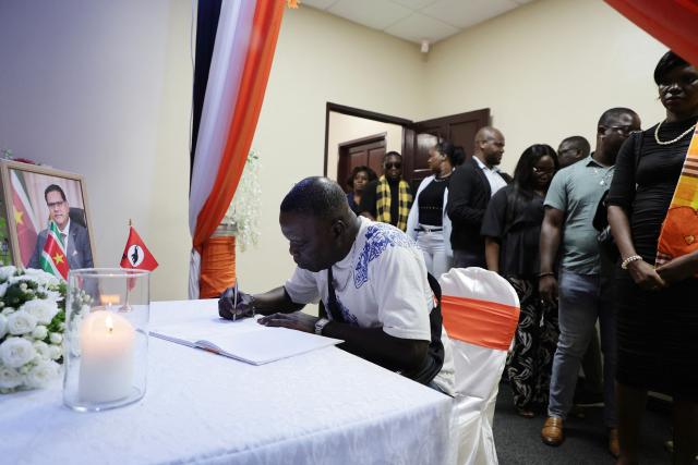 A man signs a condolence register for late former president Chandrikapersad Santokhi at the Vooruitstrevende Hervormingspartij (VHP) center in Paramaribo on April 2, 2026. Former Surinamese President Chan Santokhi, known for his investigation into the 1982 massacre of opposition members during the dictatorship of Desi Bouterse, has died at the age of 67, the government announced on March 30, 2026. Santokhi served as president of Suriname from 2020 to 2025, when he handed over power to opposition leader Jennifer Geerlings-Simons. (Photo by Ranu ABHELAKH / AFP)