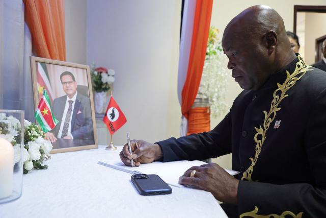 Suriname's former Vice President Ronnie Brunswijk signs a condolence register for late former president Chandrikapersad Santokhi at the Vooruitstrevende Hervormingspartij (VHP) center in Paramaribo on April 2, 2026. Former Surinamese President Chan Santokhi, known for his investigation into the 1982 massacre of opposition members during the dictatorship of Desi Bouterse, has died at the age of 67, the government announced on March 30, 2026. Santokhi served as president of Suriname from 2020 to 2025, when he handed over power to opposition leader Jennifer Geerlings-Simons. (Photo by Ranu ABHELAKH / AFP)