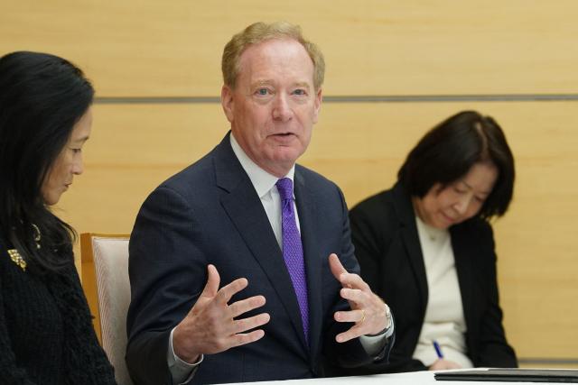 Microsoft's Vice Chair and President Brad Smith (C) speaks during a meeting with Japan’s Prime Minister Sanae Takaichi at the Prime Minister’s Office in Tokyo on April 3, 2026. (Photo by Kazuhiro NOGI / POOL / AFP)