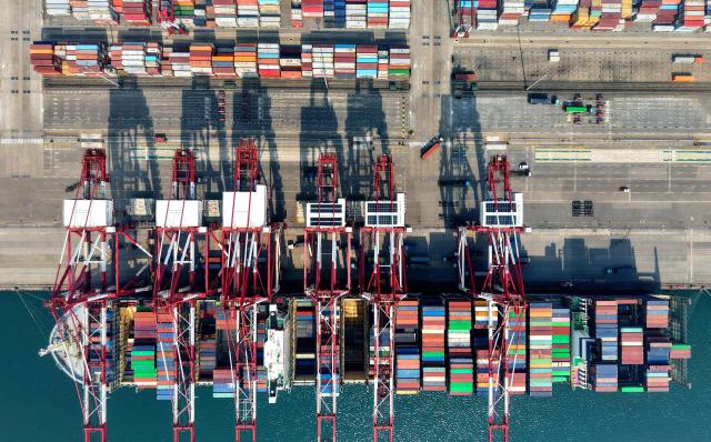 TOPSHOT - A container ship is seen at berth at the container terminal of the port in Qingdao, in China’s eastern Shandong province on April 2, 2026. (Photo by CN-STR / AFP) / China OUT